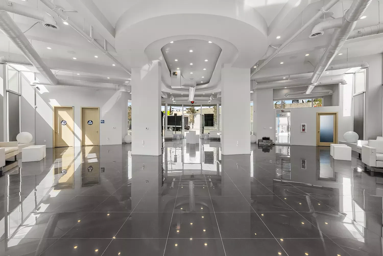 Open event floor with polished tile and arched ceiling details